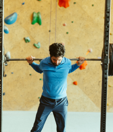 Man lifting a barbell at Boston Bouldering Project