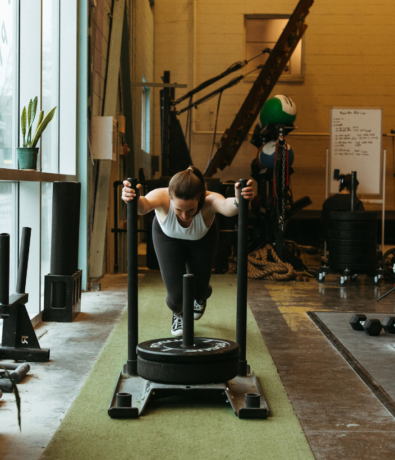 Woman pushes weights in an open fitness area
