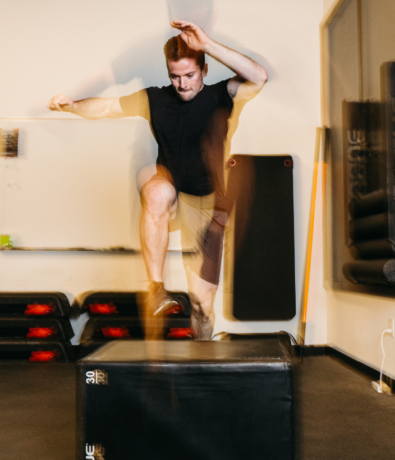 Man exercising in a strength and HIIT class