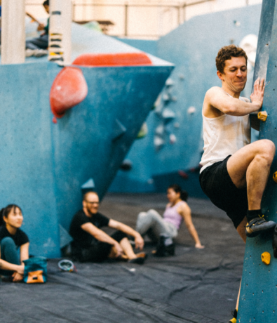 Man climbs an intermediate rock climbing route at bouldering project