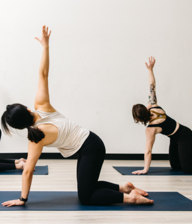 Two people doing yoga at Boston Bouldering Project