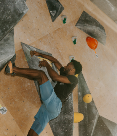 Man rock climbing in DC at Bouldering Project