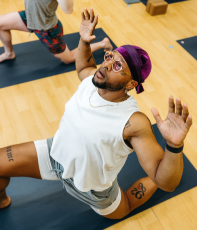 Person in low lunge pose during a Flow Yoga class in DC
