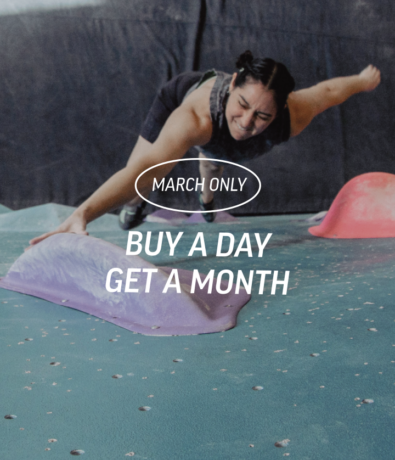 A woman climbs on a bouldering wall, reaching for a purple hold. Text overlay reads: March Only. Buy a day, get a month.