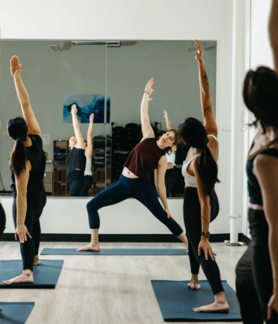 Yoga instructor guiding a class at Boston Bouldering Project