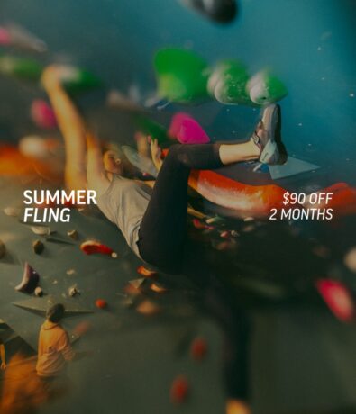A person climbs an indoor bouldering wall with colorful holds. Text reads SUMMER FLING and $90 OFF 2 MONTHS. The scene is dynamic and slightly blurred, emphasizing motion.