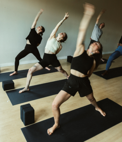 Three people doing yoga in Brooklyn