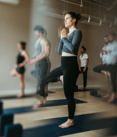 Woman in tree pose during a yoga class in Brooklyn