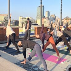 group doing yoga on a rooftop in Brooklyn, NY