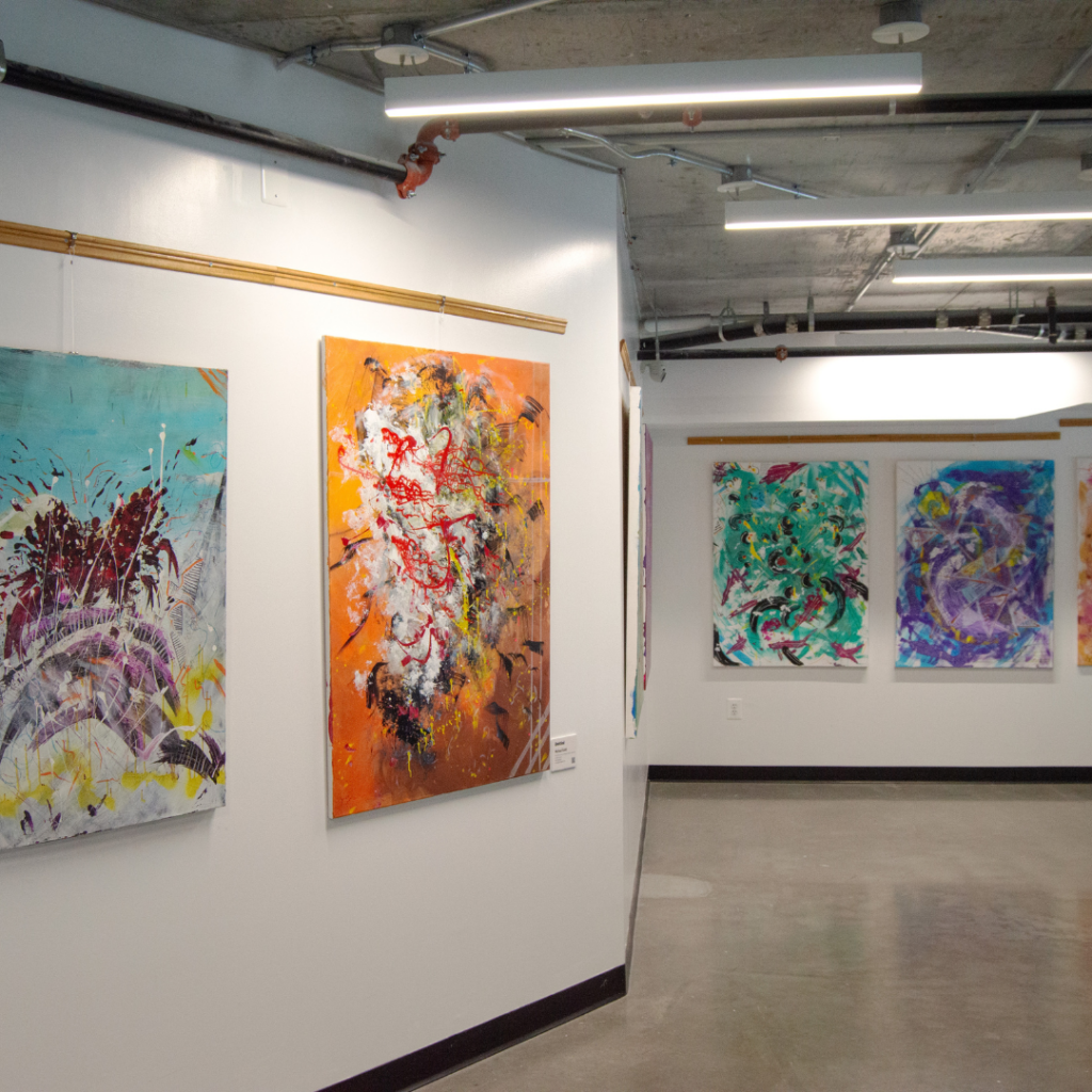 Artwork by Michael Guild. A series of abstract paintings hanging along the main upstairs hallway at DC Bouldering Project.