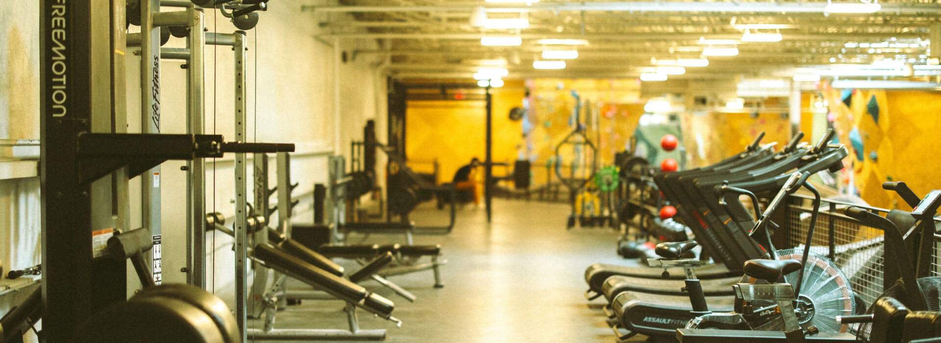 Cardio and weightlifting equipment at Boston Bouldering Project