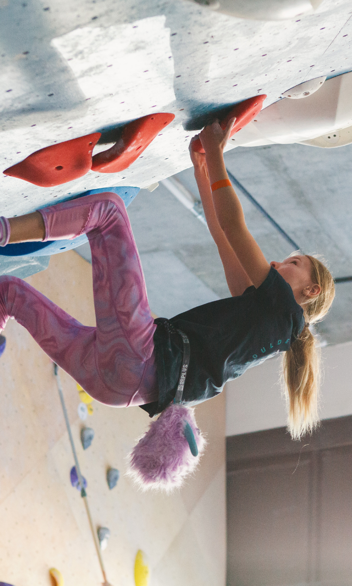 Competitive youth team member climbing in DC at Bouldering Project