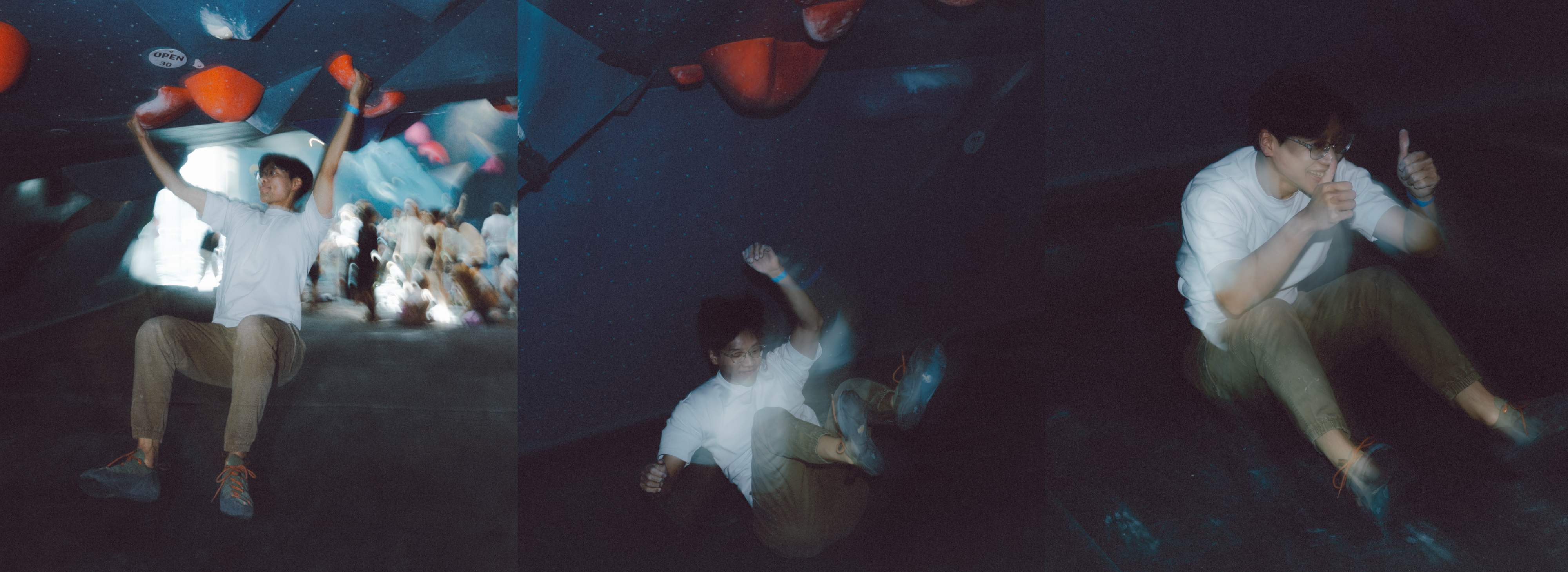 A young man in a white shirt and glasses falls while bouldering indoors, shown in three sequence shots: hanging on, slipping off, and sitting on the ground giving a thumbs-up.