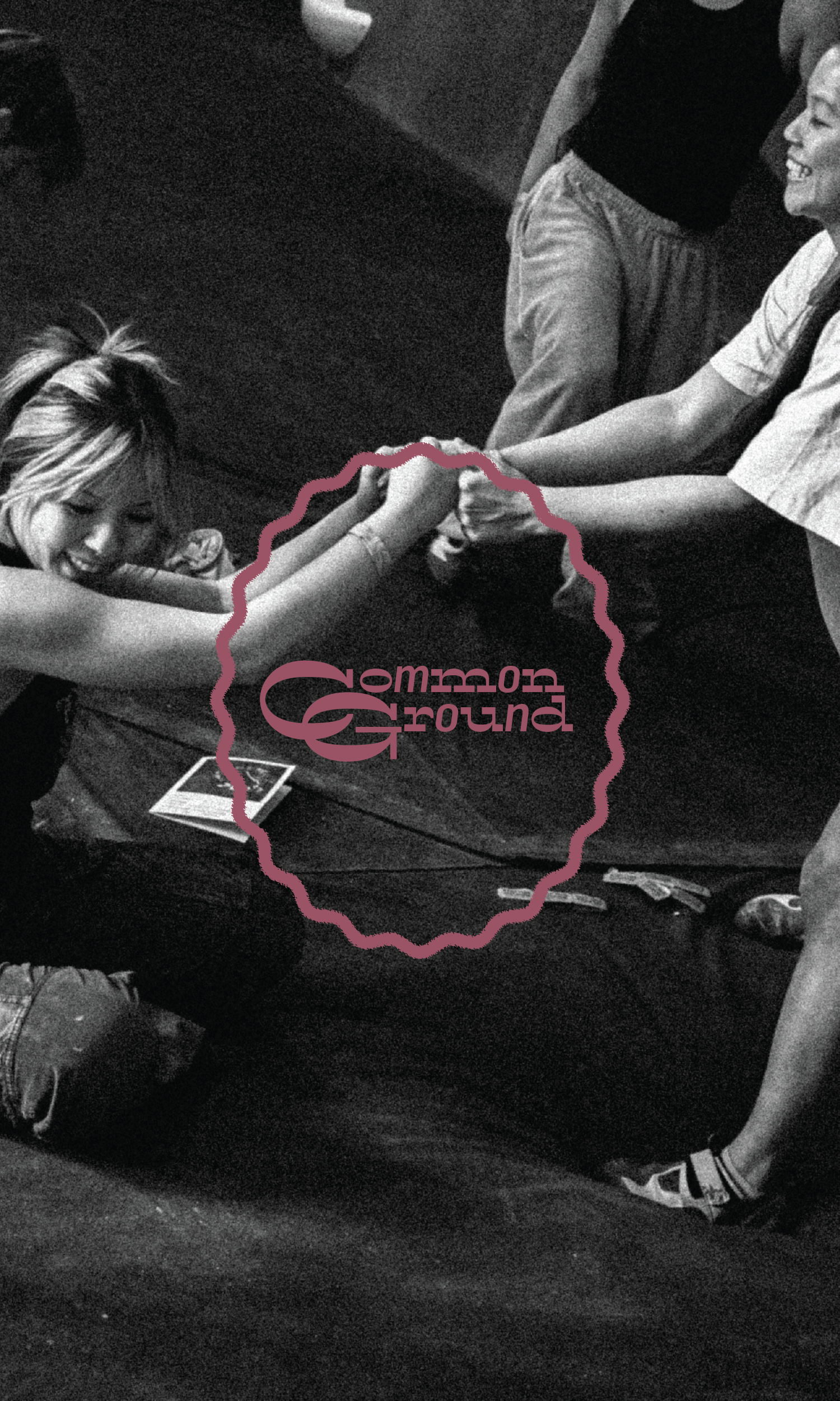 Two women smile and high five on a gym mat, celebrating at the Seattle Boulderfest competition. 