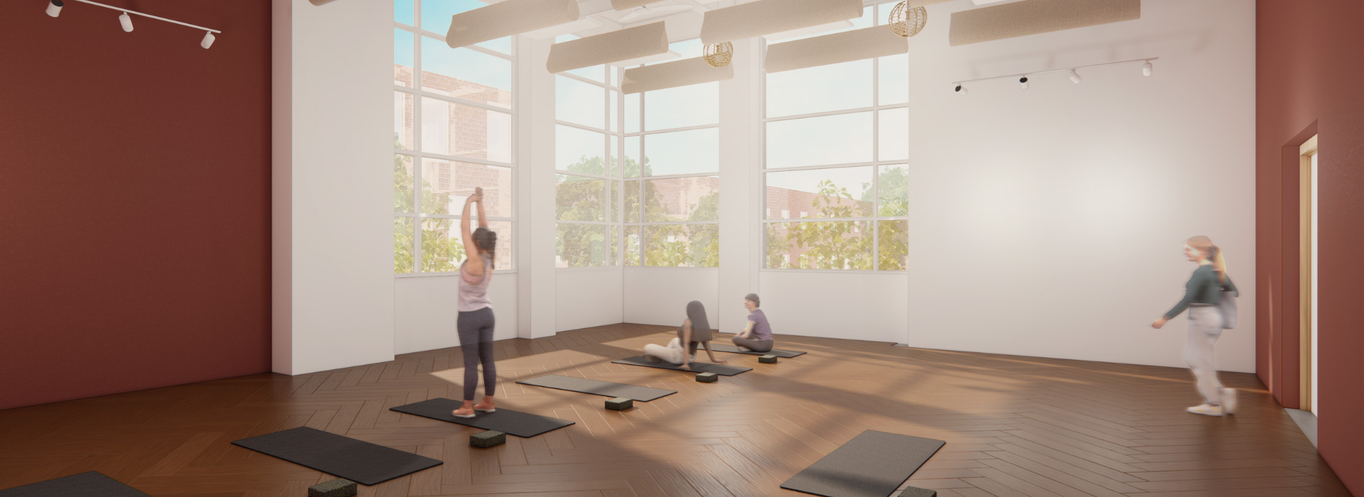 A spacious, sunlit room with wooden floors and maroon walls, where four people are practicing yoga on black mats near large windows, reminiscent of the open studio spaces often found in a DC climbing gym.