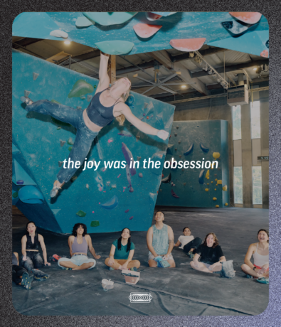 A climber hangs from a blue bouldering wall above people on the gym floor, overlaid with the text the joy was in the obsession, serving as the centerpiece for a brand campaign landing page.