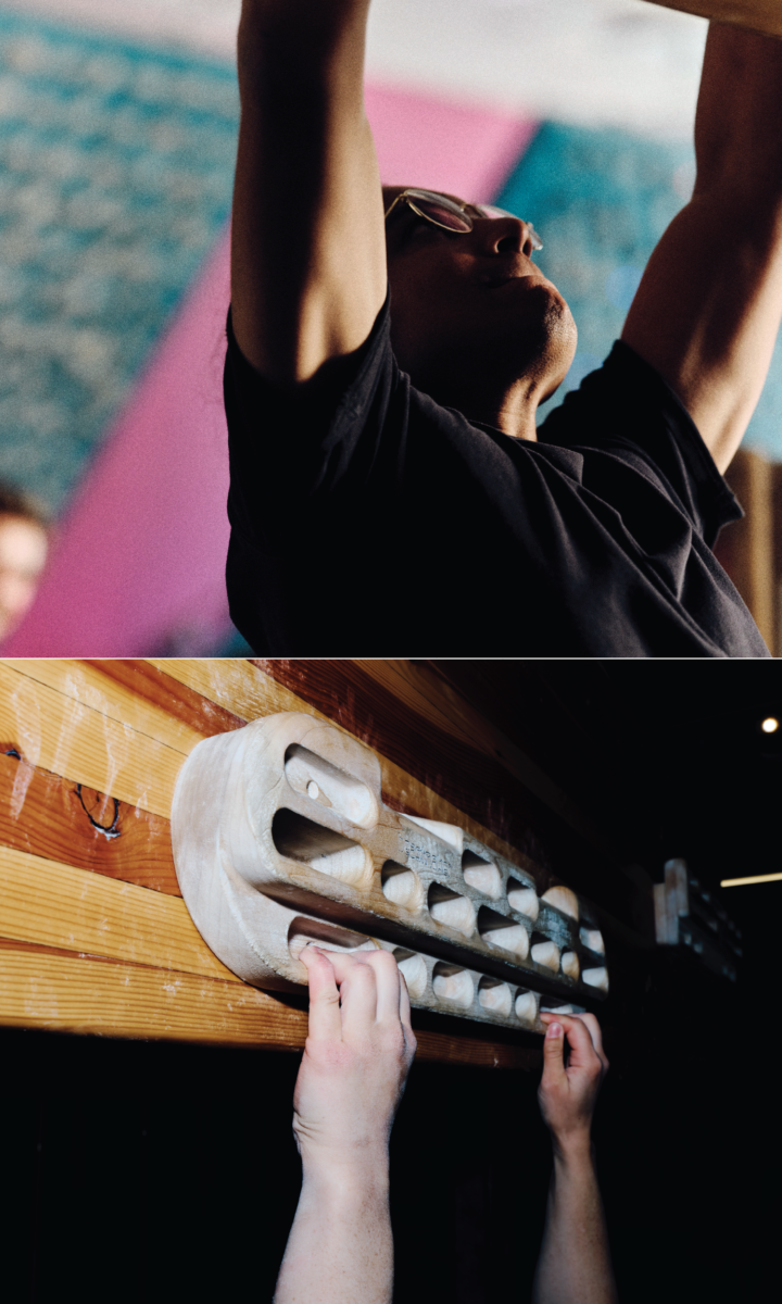 A person in a state of joyful obsession hanging from a wooden climbing hangboard with both hands.